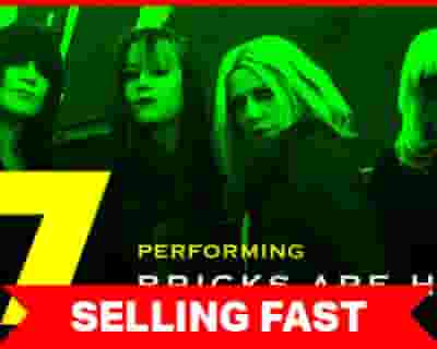 L7 performing Bricks Are Heavy tickets blurred poster image